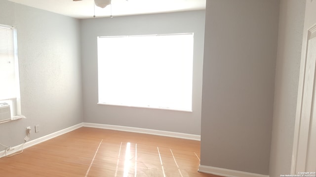 spare room with ceiling fan and hardwood / wood-style flooring