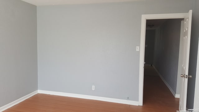 empty room with hardwood / wood-style floors