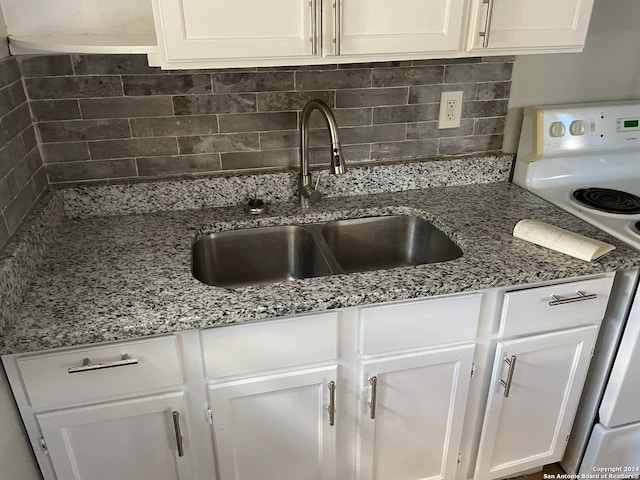 kitchen with backsplash, white electric range, sink, and white cabinets