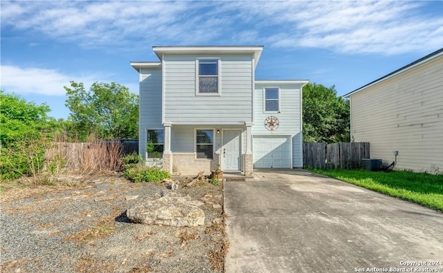 view of front property featuring a garage and central AC