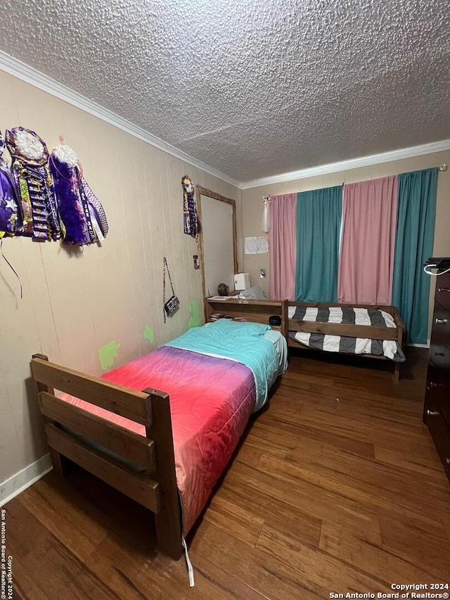 bedroom with wood-type flooring, a textured ceiling, and crown molding