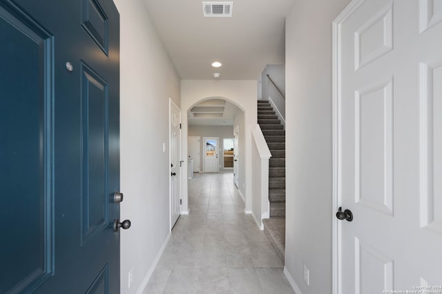 corridor featuring light tile patterned floors