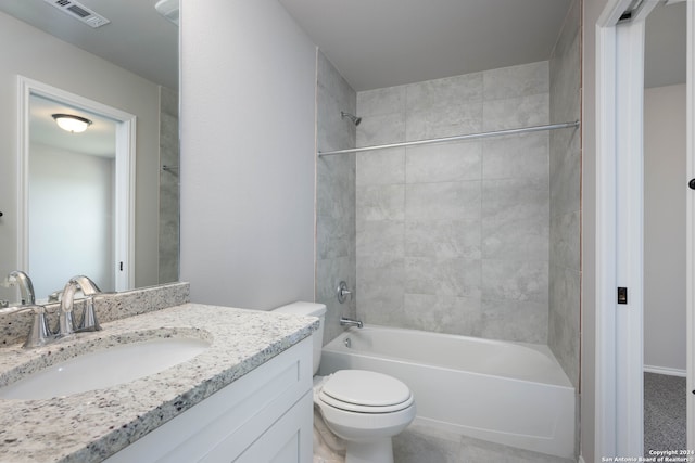 full bathroom featuring tiled shower / bath, vanity, and toilet