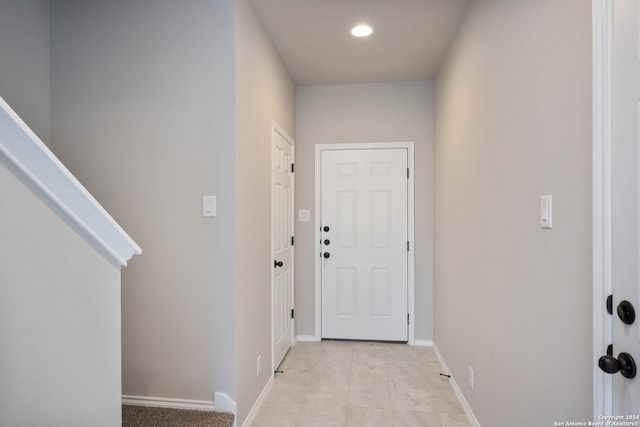 doorway to outside with light tile patterned flooring