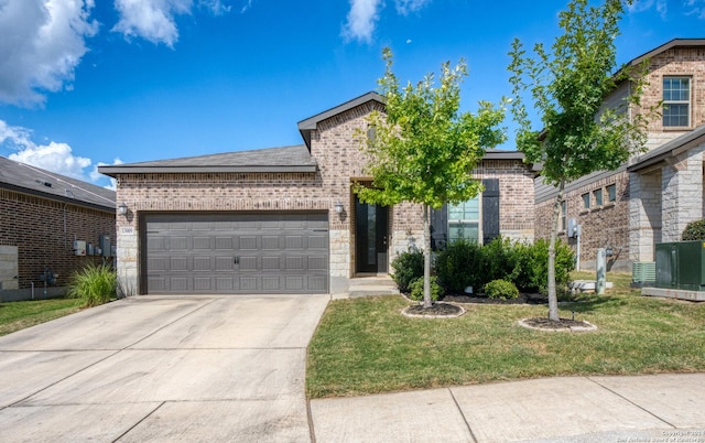 view of front of house with a front yard and a garage