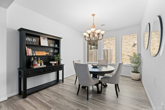 dining room featuring a chandelier and hardwood / wood-style flooring