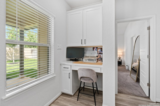 office area with light hardwood / wood-style flooring and built in desk