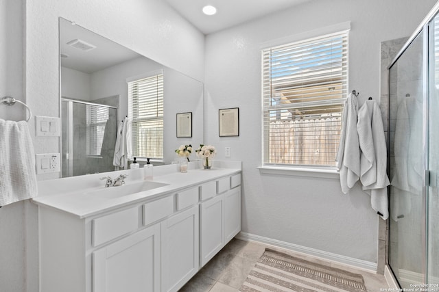 bathroom with vanity, plenty of natural light, and a shower with shower door