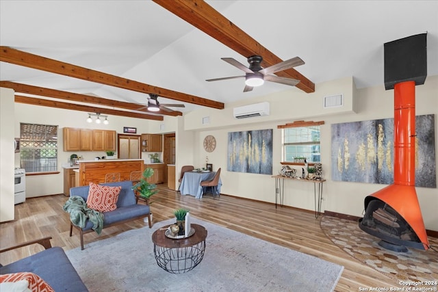 living room featuring light wood-type flooring, a wall unit AC, and plenty of natural light