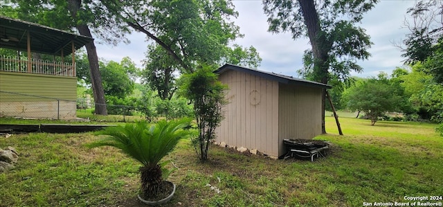 view of outbuilding with a yard