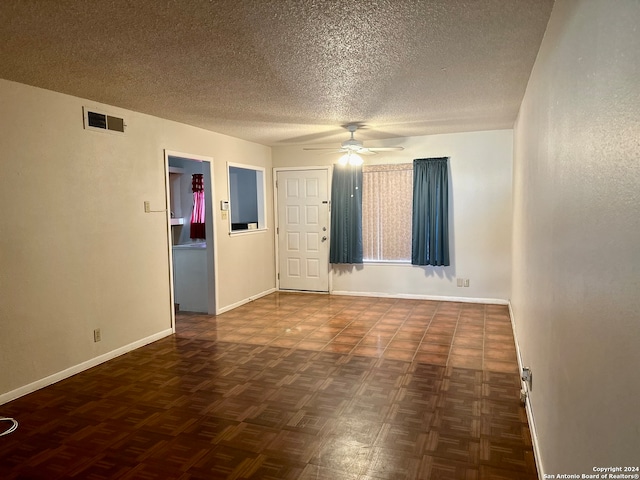 spare room featuring ceiling fan and a textured ceiling