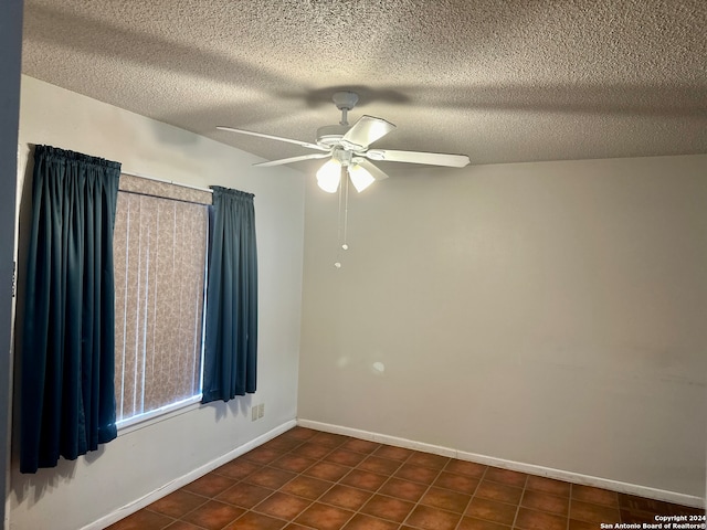 empty room featuring ceiling fan and a textured ceiling