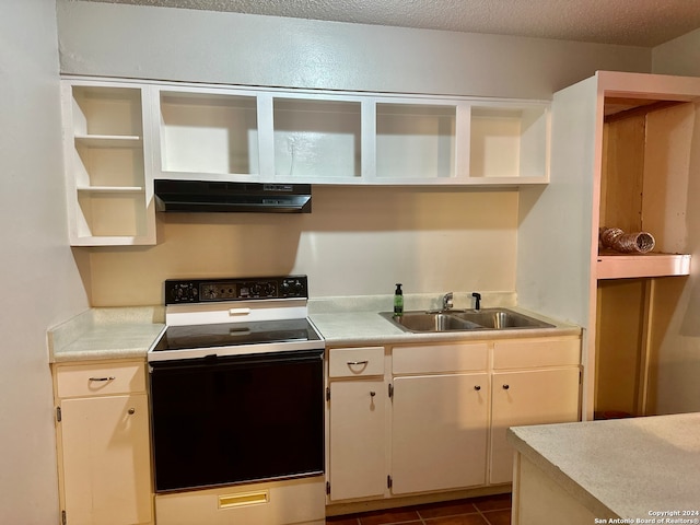 kitchen featuring ventilation hood, a textured ceiling, white electric stove, dark tile patterned floors, and sink