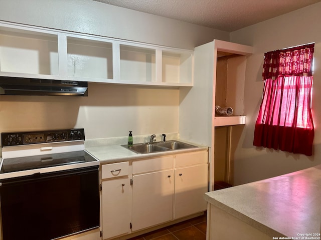 kitchen featuring sink, a textured ceiling, range with electric cooktop, white cabinetry, and exhaust hood