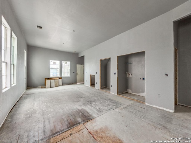 unfurnished living room featuring visible vents