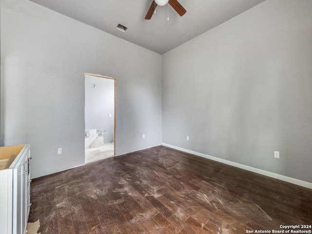 unfurnished room with ceiling fan and dark wood-type flooring