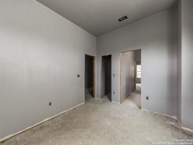 unfurnished bedroom with a high ceiling