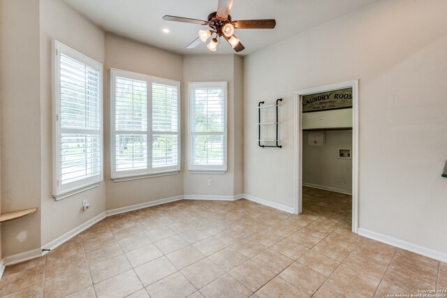 unfurnished room with ceiling fan and light tile patterned floors