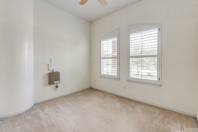 unfurnished room featuring ceiling fan and light colored carpet