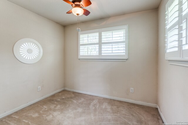 carpeted empty room featuring ceiling fan