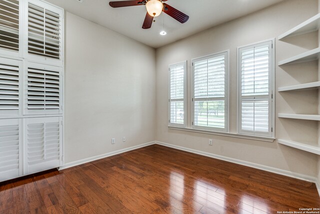 unfurnished bedroom featuring ceiling fan and dark hardwood / wood-style flooring