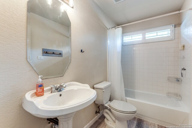 bathroom with shower / tub combo with curtain, toilet, and hardwood / wood-style flooring