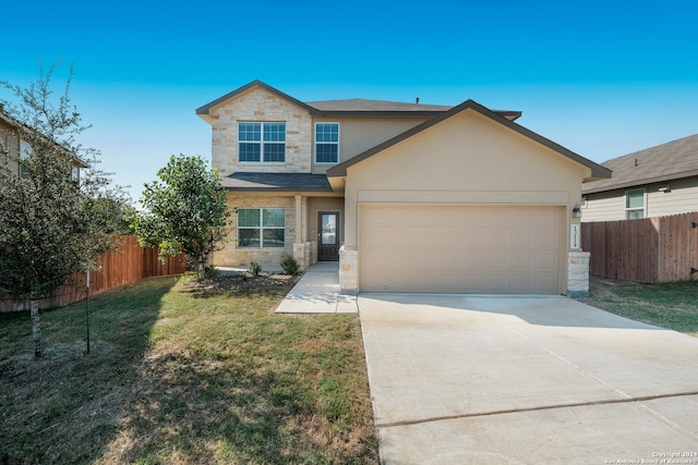 view of front of property with a front lawn and a garage