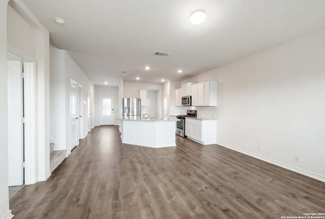 kitchen featuring white cabinets, a kitchen island with sink, stainless steel appliances, and hardwood / wood-style floors