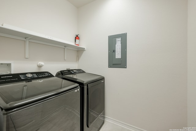 laundry area featuring light tile patterned flooring, electric panel, and independent washer and dryer