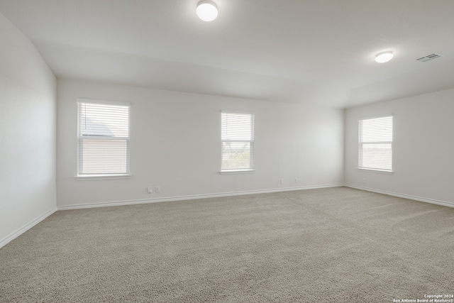 spare room with light colored carpet