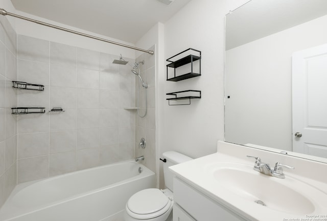 full bathroom featuring vanity, tiled shower / bath combo, and toilet