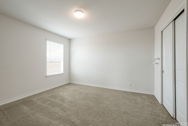 unfurnished bedroom with carpet and a closet