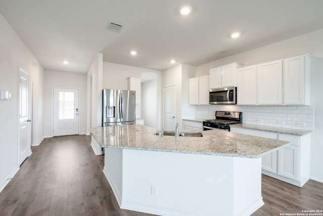 kitchen with white cabinetry, a center island with sink, and appliances with stainless steel finishes