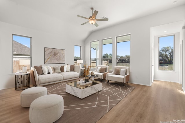 living room featuring ceiling fan, wood-type flooring, and lofted ceiling