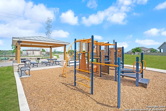 view of playground featuring a gazebo and a lawn