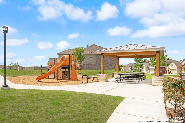 view of playground with a lawn, a gazebo, and a patio