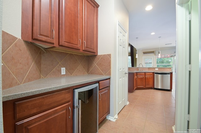 kitchen with pendant lighting, wine cooler, light tile patterned flooring, sink, and stainless steel dishwasher