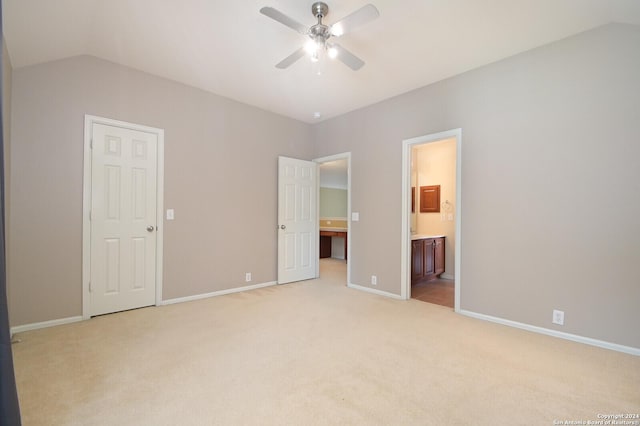 10606 Rainbow Vw, Helotes, TX 78023 - unfurnished bedroom with light colored carpet, baseboards, and vaulted ceiling