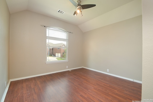 spare room with vaulted ceiling, ceiling fan, and dark hardwood / wood-style floors