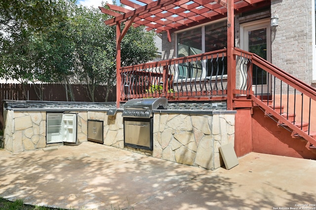 view of patio featuring an outdoor kitchen and a grill