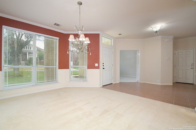 spare room featuring crown molding, tile patterned floors, and a notable chandelier