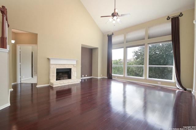 unfurnished living room with a fireplace, dark hardwood / wood-style flooring, ceiling fan, and high vaulted ceiling