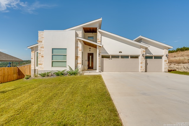 modern home with a front yard and a garage