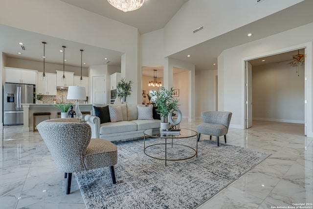 living room featuring a high ceiling and an inviting chandelier