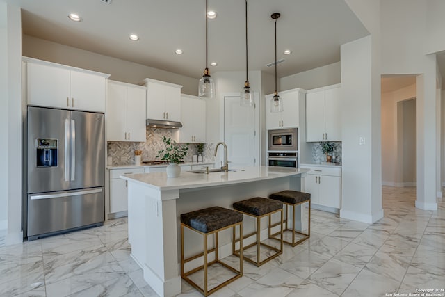 kitchen with sink, white cabinetry, a kitchen island with sink, and appliances with stainless steel finishes