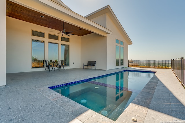 view of swimming pool with ceiling fan and a patio area