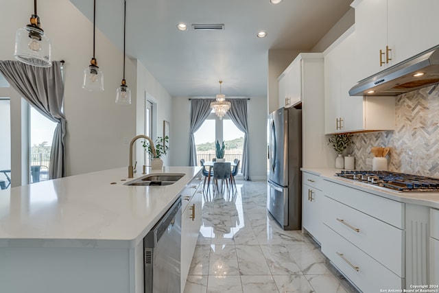 kitchen with white cabinetry, sink, stainless steel appliances, and a center island with sink