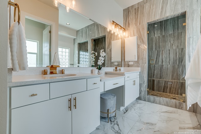 bathroom featuring a tile shower, vanity, and tile walls