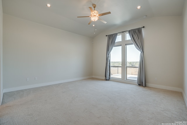 carpeted empty room featuring ceiling fan and lofted ceiling