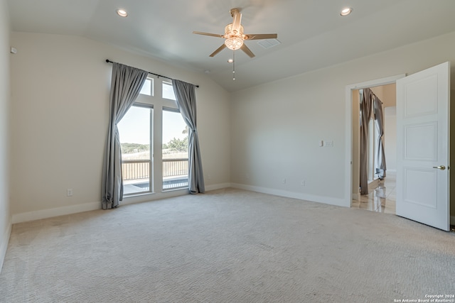 empty room with ceiling fan, light carpet, and lofted ceiling